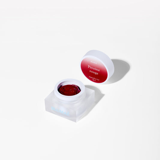 Red gel in a white container with a red lid on a white background
